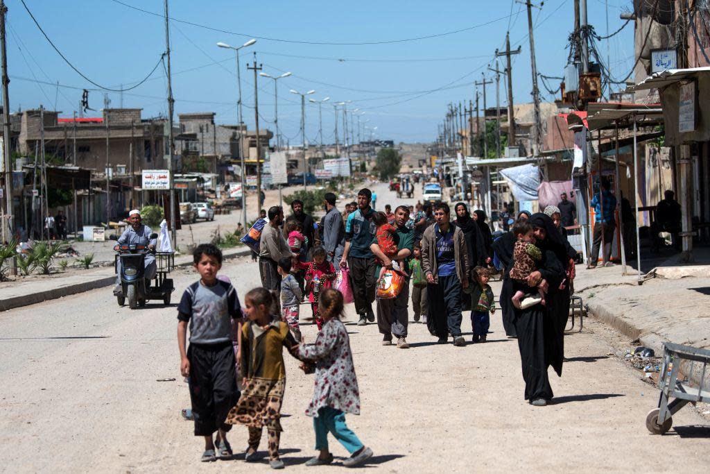 Families evacuate from front-line positions in the western part of Mosul on 24 April 2017, as Iraqi forces continue the offensive to retake the area from Isis: AFP/Getty Images