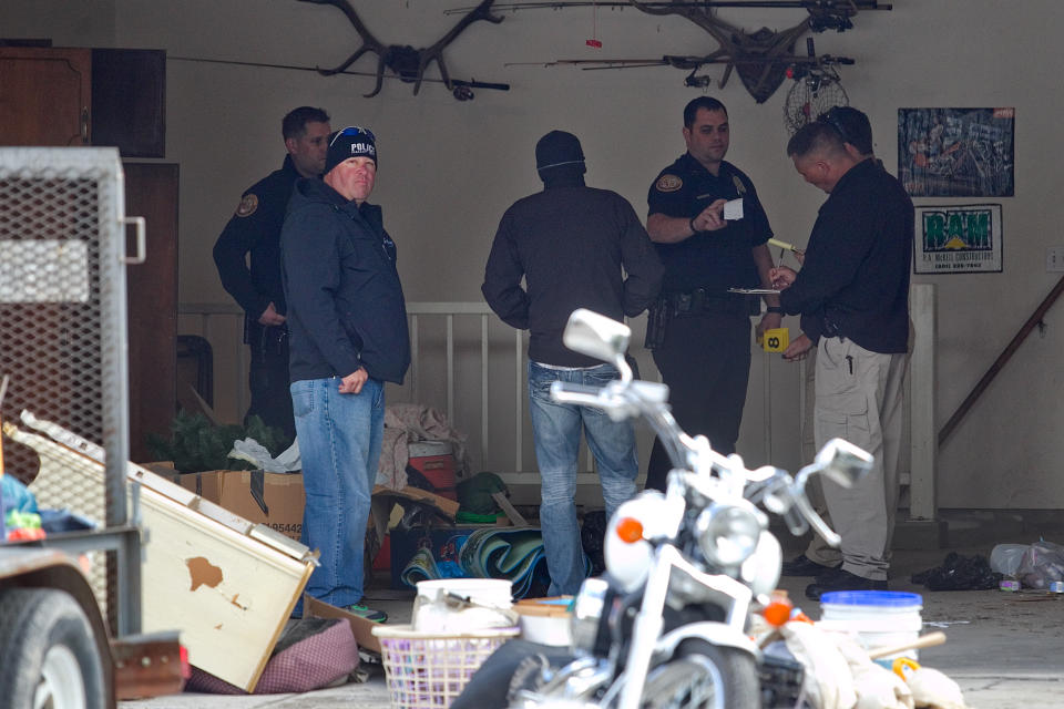 Authorities investigate a crime scene at a house in Pleasant Grove, Utah, Sunday, April 13, 2014. According to the Pleasant Grove Police Department, seven dead infants were found in the former home of Megan Huntsman, 39. Huntsman was booked into jail on six counts of murder. (AP Photo/Daily Herald, Mark Johnston)