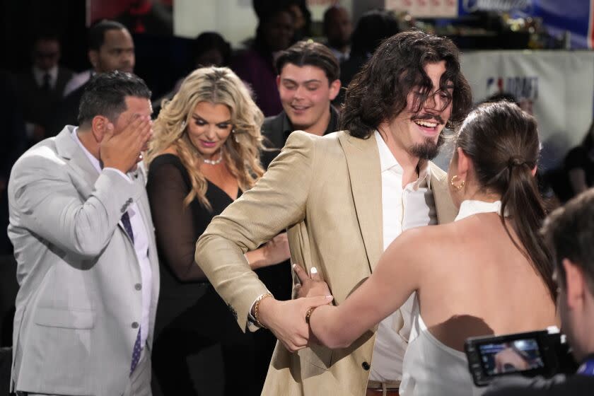 Jaime Jaquez Jr. celebrates with family and friends after being selected 18th overall by the Miami Heat during the NBA basketball draft, Thursday, June 22, 2023, in New York. (AP Photo/John Minchillo)