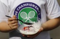 5 year old Jade Haddad shows off her Strawberries and cream at the Wimbledon Tennis Championships in London, July 2, 2015. REUTERS/Suzanne Plunkett