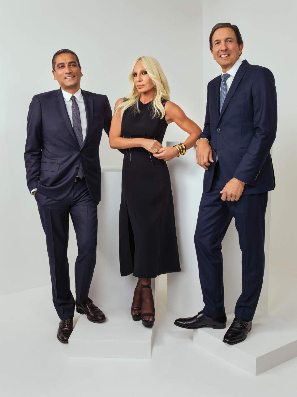 This undated photo provided by Michael Kors shows from left, CEO of Versace Jonathan Akeroyd, Donatella Versace, and chairman and CEO of Michael Kors John D. Idol. Michael Kors is buying the Italian fashion house Versace in a deal worth more than $2 billion, continuing its hard charge into the world of high-end fashion. (Rahi Rezvani/Michael Kors Holdings Ltd. via AP)