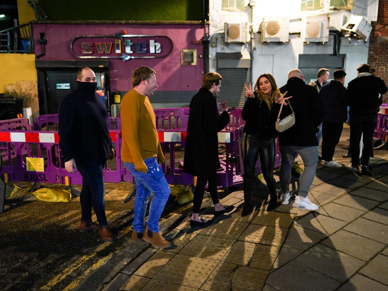 Customers wait outside the Switch bar in Newcastle as it prepares to serve customers after midnight to mark the latest lifting of lockdown measures (Getty Images)