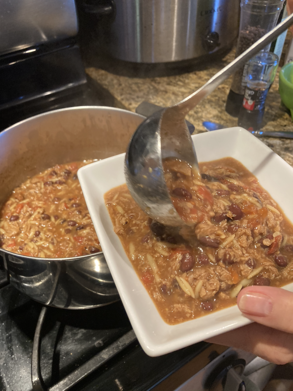 the author scooping chili into her bowl