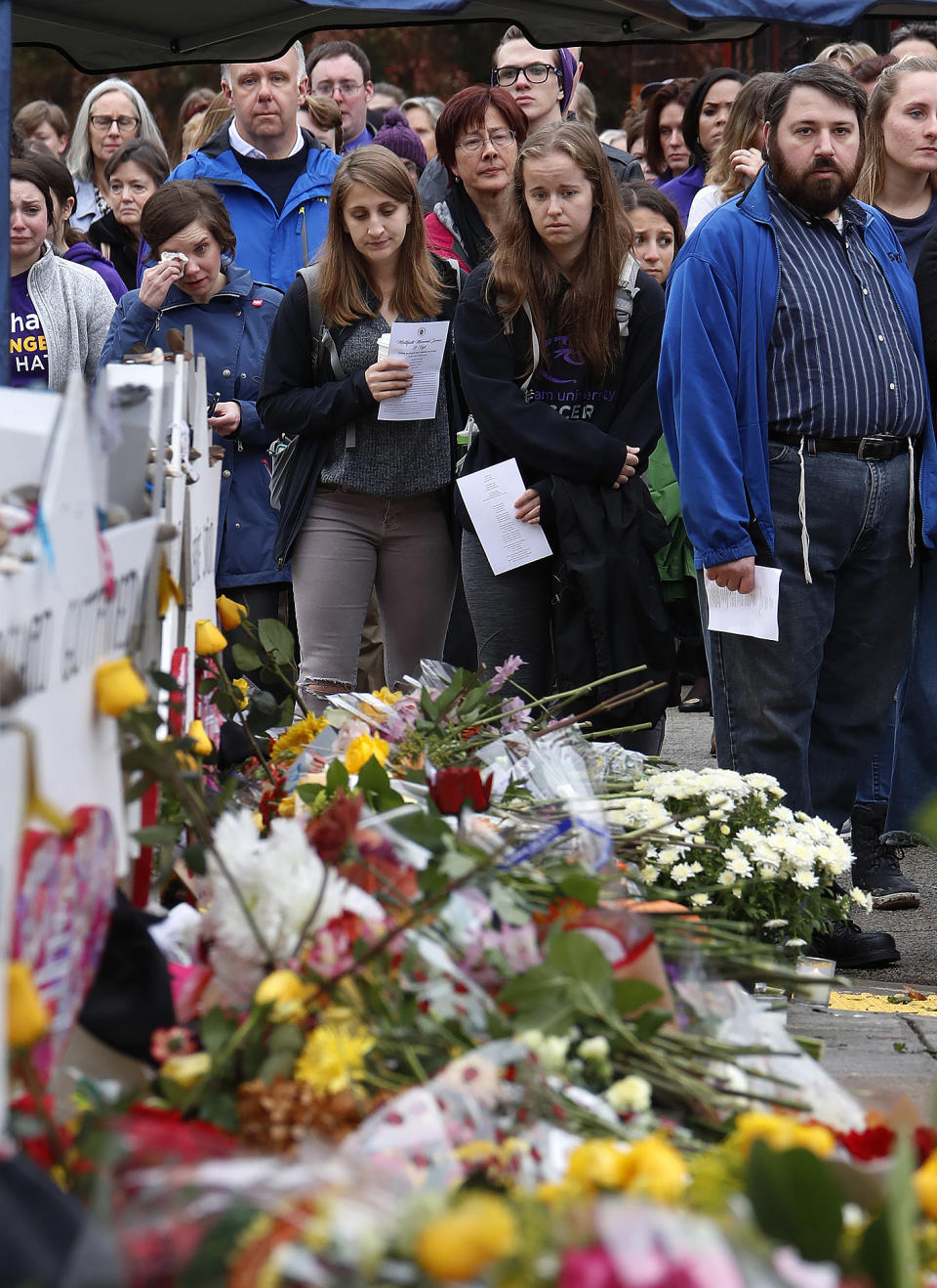 People pay their respects Thursday, Nov. 1, 2018, at a makeshift memorial outside the Tree of Life Synagogue to the 11 people killed Oct 27, 2018 while worshipping in the Squirrel Hill neighborhood of Pittsburgh.(AP Photo/Gene J. Puskar)