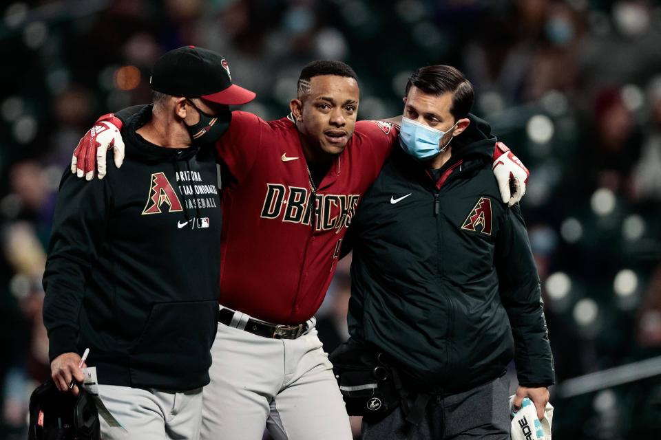 Arizona Diamondbacks center fielder Ketel Marte is helped off the field.