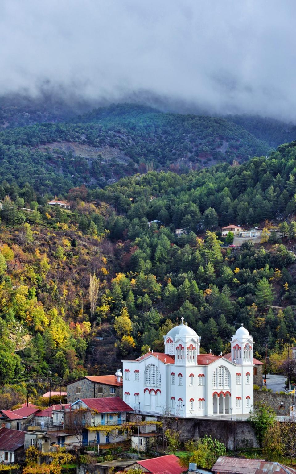 church amid greenery of mountain, plus fog