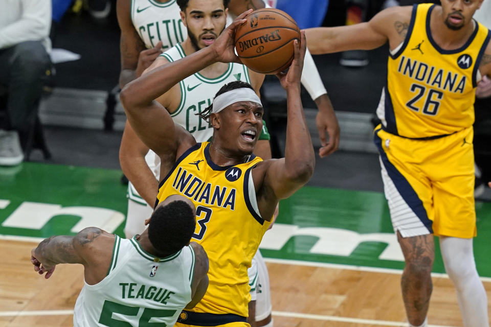 Indiana Pacers center Myles Turner (33) goes to the hoop against Boston Celtics guard Jeff Teague (55) in the first quarter of an NBA basketball game, Friday, Feb. 26, 2021, in Boston. (AP Photo/Elise Amendola)