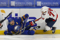 Buffalo Sabres forward Sam Reinhart (23) and Washington Capitals forward Conor Sheary (73) collide during the second period of an NHL hockey game Friday, Jan. 15, 2021, in Buffalo, N.Y. (AP Photo/Jeffrey T. Barnes)