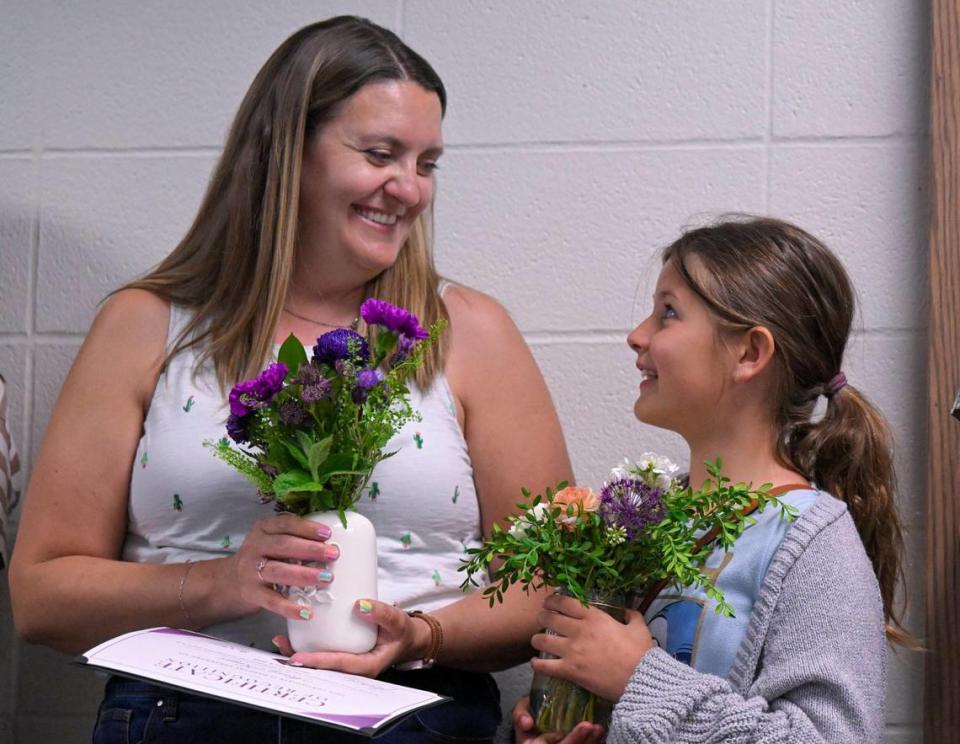 Mary Krejci, a teacher at Piper Prairie Elementary School, shares a smile with her daughter, Sawyer Krejci, 10, after she was announced as the winner of the Kansas City Star’s Honor Roll teacher poll. The announcement was made during a school board meeting May 8, 2023 at Piper East Elementary in Kansas City, Kansas.