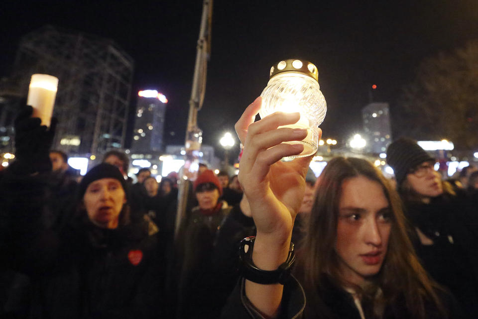 People hold lit candles in a memorial march for Gdansk Mayor Pawel Adamowicz, in Warsaw, Poland, Monday, Jan. 14, 2019. People in Poland are gathering for solemn vigils to honor Gdansk Mayor, 53-year-old Pawel Adamowicz. who died Monday after being stabbed at a fundraising event the night before. There were vigils in Warsaw and other cities across a nation shocked by the assassination. (AP Photo/Czarek Sokolowski)