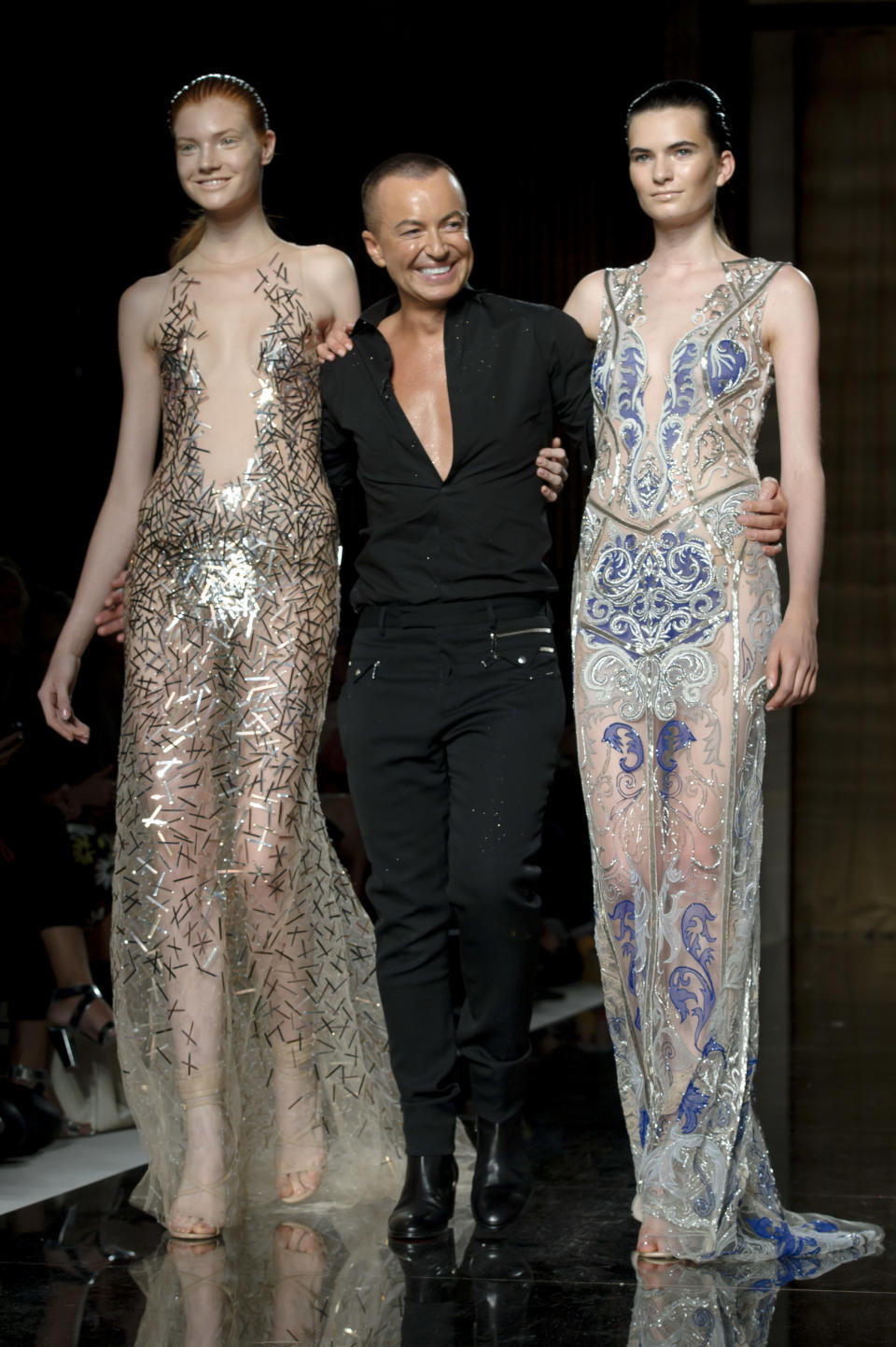 British designer Julien Macdonald, center, and models at the end of the Julien Macdonald show during London Fashion Week Spring/Summer 2014, at Goldsmiths Hall in central London, Saturday, Sept. 14, 2013. (Photo by Jonathan Short/Invision/AP)