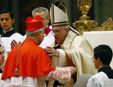 Pope Francis (R) embraces newly elevated Cardinal Dominique Mamberti during a mass to create 20 new cardinals during a ceremony in St. Peter's Basilica at the Vatican February 14, 2015. REUTERS/Tony Gentile