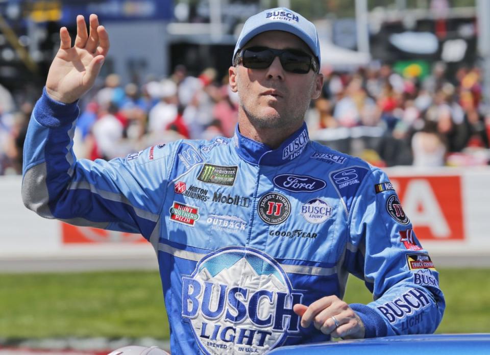 Kevin Harvick waves to the crowd during driver introductions prior to the race at Richmond International Raceway. (AP Photo/Steve Helber)