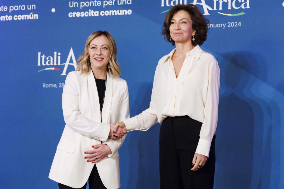 Italian Premier Giorgia Meloni, left, welcomes Unesco Director Audrey Azoulay on the occasion of an Italy - Africa summit, in Rome, Monday, Jan. 29, 2024. Meloni opened a summit of African leaders on Monday aimed at illustrating Italy's big development plan for the continent that her government hopes will stem migration flows and forge a new relationship between Europe and Africa. (Roberto Monaldo/LaPresse via AP)