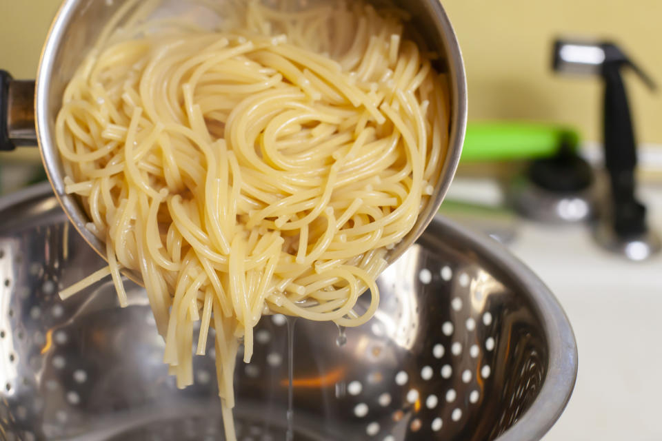 Pasta being poured into a strainer