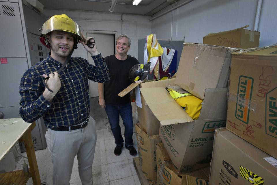 Ilya Soroka and Taylor Smith display some of the used firefighting equipment donated to be sent to Ukraine. Some of it smells, they said, but it will still be much needed in the war-torn country. They have both made trips to Ukraine and have seen firsthand the needs of the country in the midst of war with Russia.