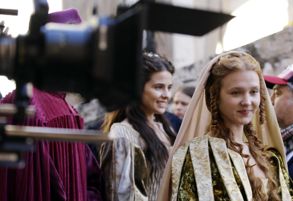 In this photo taken Monday, Oct. 29, 2012, actress Isolda Dychauk playing the character of Lucrezia Borgia waits for the start of the shooting of "Borgia" tv series, in Sermoneta, Italy. The Italian economy may be struggling but the pan-European television series “Borgia,” which is now filming its second season in Italy, is a thriving hit on the world market. Spanning the late Middle Ages to the early Renaissance period, the show follows the famous Borgia family's rise to power and subsequent domination of the Vatican and southern Europe's political landscape. A winning combination of sex, violence, faith, lust and betrayal, the primarily French-German production has been sold in 85 countries worldwide. (AP Photo/Gregorio Borgia)