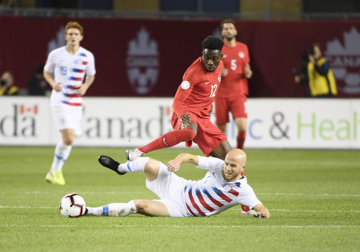 Michael Bradley (bottom) and the USMNT hit their lowest point since failing to qualify for the 2018 World Cup against Alphonso Davies and Canada. (USA Today)