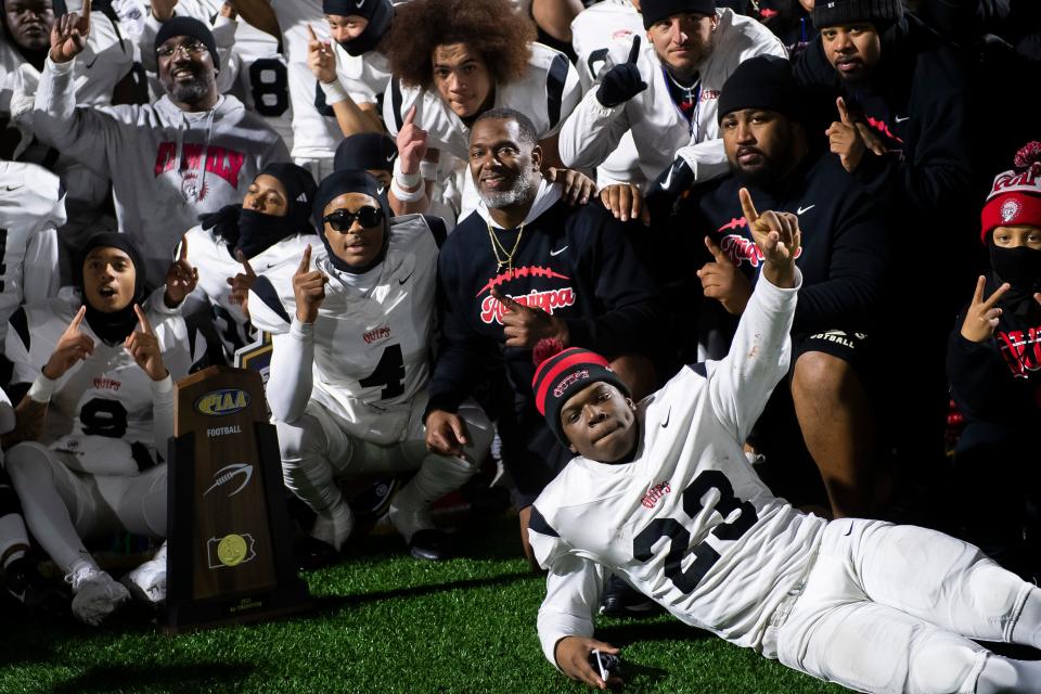 Aliquippa football team members, including junior Tiqwai Hayes (23), pose for a group photo after winning the PIAA Class 4A football championship game against Dallas at Cumberland Valley High School, Thursday, Dec. 7, 2023, in Mechanicsburg, Pa. The Quips won their fifth state title, 60-14.