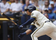 Milwaukee Brewers' Eduardo Escobar hits a run-scoring single against the Pittsburgh Pirates during the third inning of a baseball game Wednesday, Aug. 4, 2021, in Milwaukee. (AP Photo/Jeffrey Phelps)