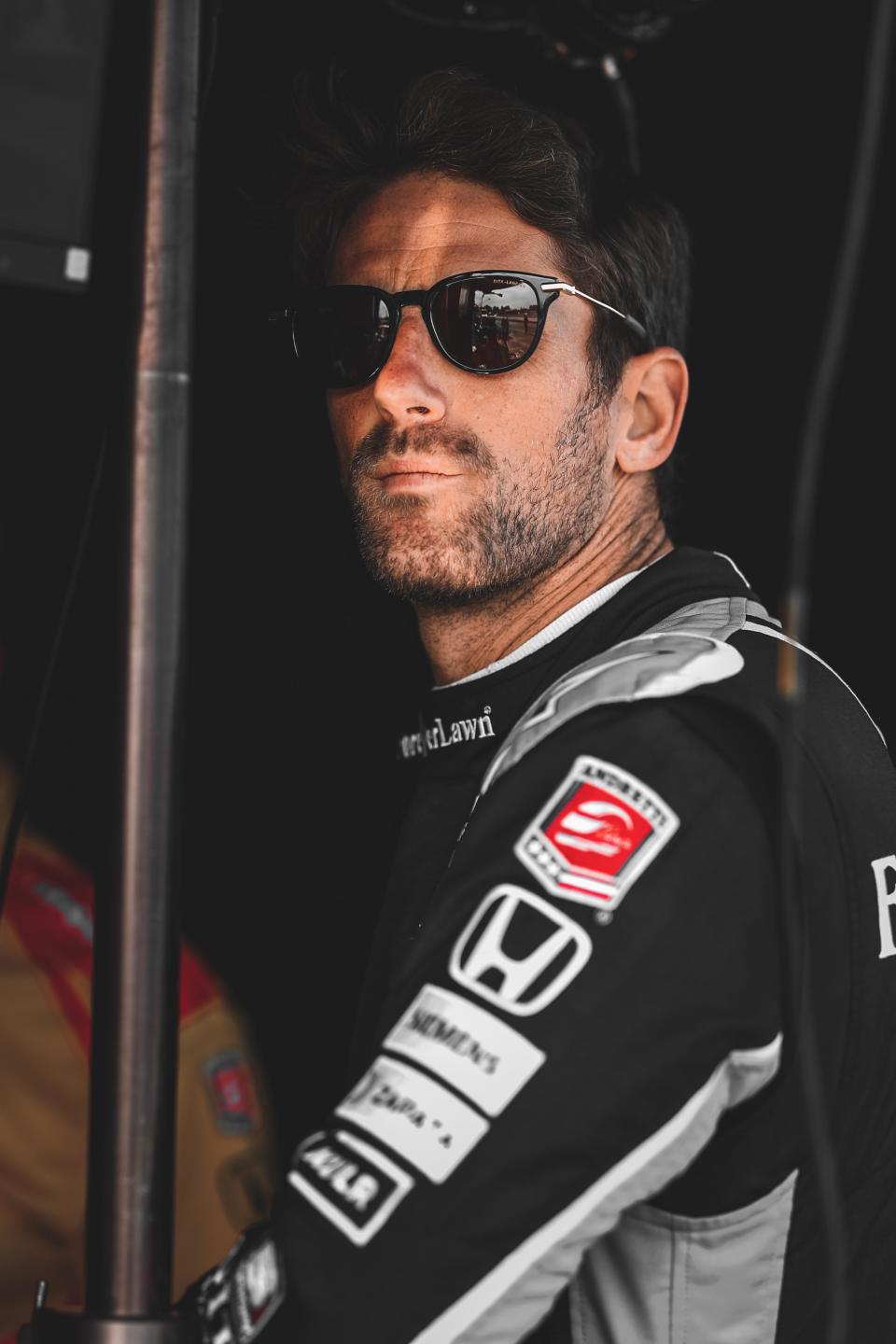 Romain Grosjean looks on from his pit box at Mid-Ohio.