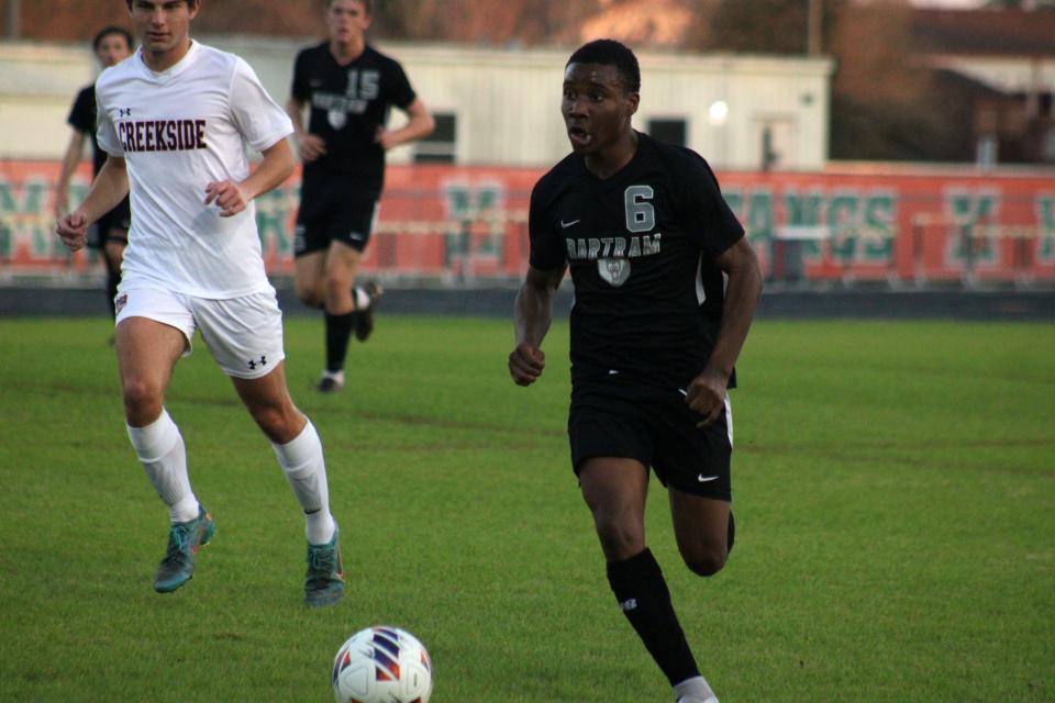 Bartram Trail forward Dimani Mathlin (6) dribbles upfield against Creekside  during a FHSAA District 1-7A high school boys soccer semifinal on January 31, 2023. [Clayton Freeman/Florida Times-Union]