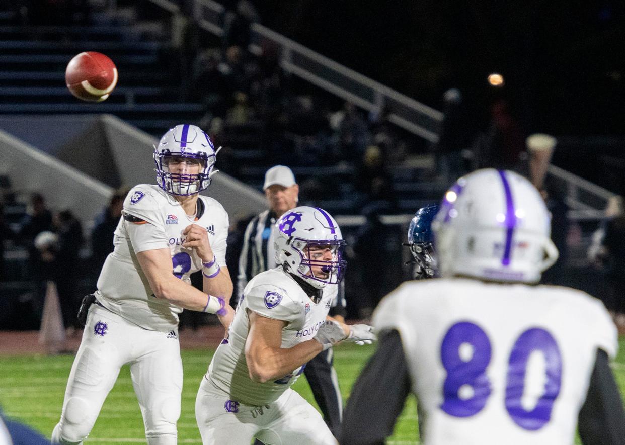 Holy Cross quarterback Matthew Sluka finds teammate Jalen Coker, right, for a first down in a 2021 game.