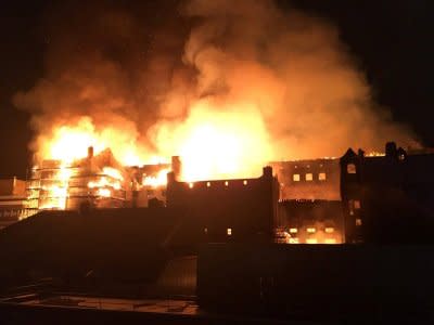 The rear elevation of the Glasgow School of Art is seen on fire, in Glasgow, Scotland, Britain, June 15, 2018, in this still image obtained from social media. TWITTER/@ Banpo_Monkey/via REUTERS