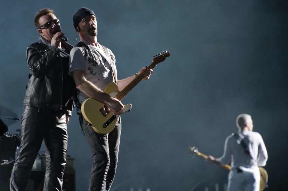 Irish rock band U2 lead singer Bono, guitarist The Edge (center) and bassist Adam Clayton (right) perform during their concert on Feb. 18, 2011, at the Green Point stadium in Cape Town, South Africa.