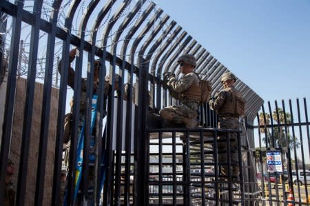 U.S. Marines with 7th Engineer Support Battalion, Special Purpose Marine Air-Ground Task Force 7, prepare to place concertina wire at the Otay Mesa Port of Entry in San Diego California, U.S., November 10, 2018.   U.S. Marine Corps/Staff Sgt. Rubin J. Tan/Handout via REUTERS