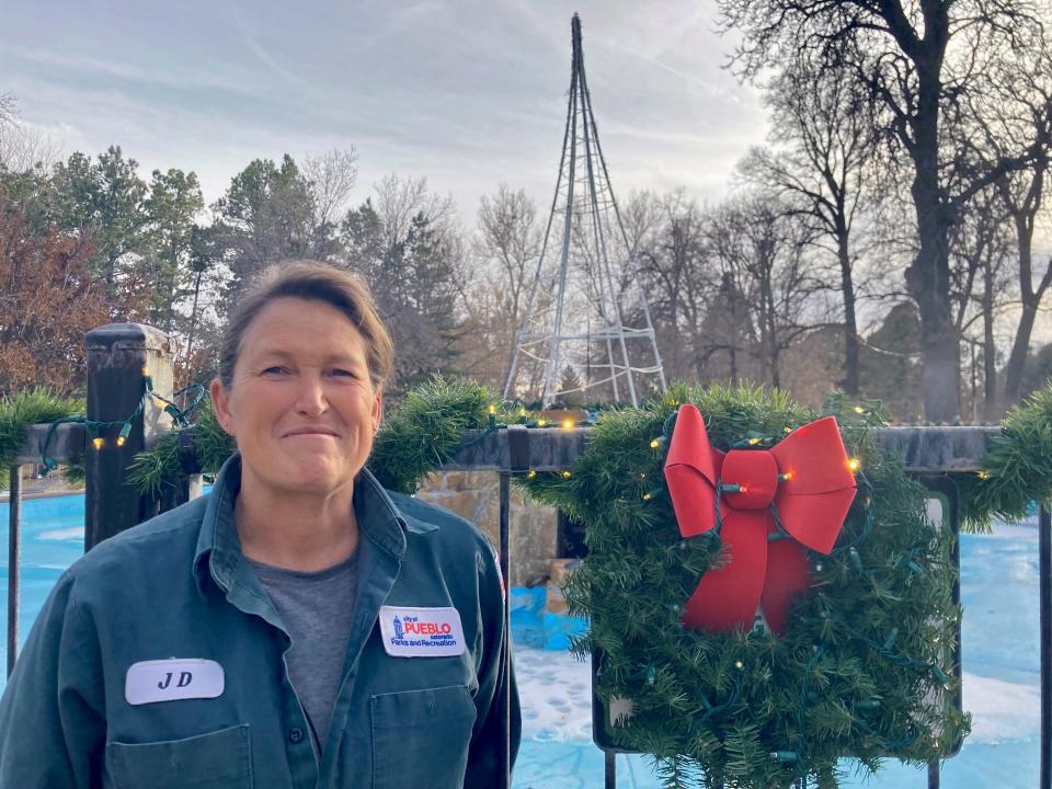 Jennifer "Jenn" Dabney, the gardener for the City of Pueblo's Parks and Recreation department, standing in front of a Christmas tree display at City Park on December 20, 2023.