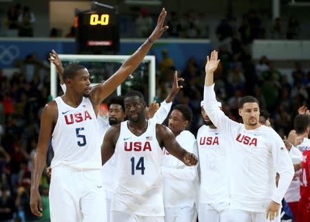 Kevin Durant, Draymond Green and Klay Thompson wave after game. REUTERS/Marko Djurica