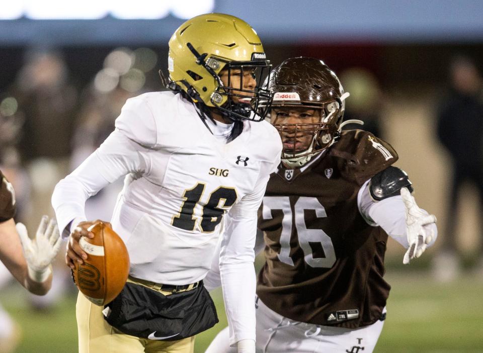 Sacred Heart-Griffin quarterback Ty Lott (16) scrambles to avoid a sack from Joliet Catholic's Dillan Johnson (76) in the first half of the IHSA Class 4A Football State Championship at Huskie Stadium in Dekalb, Ill., Friday, November 26, 2021. [Justin L. Fowler/The State Journal-Register] 