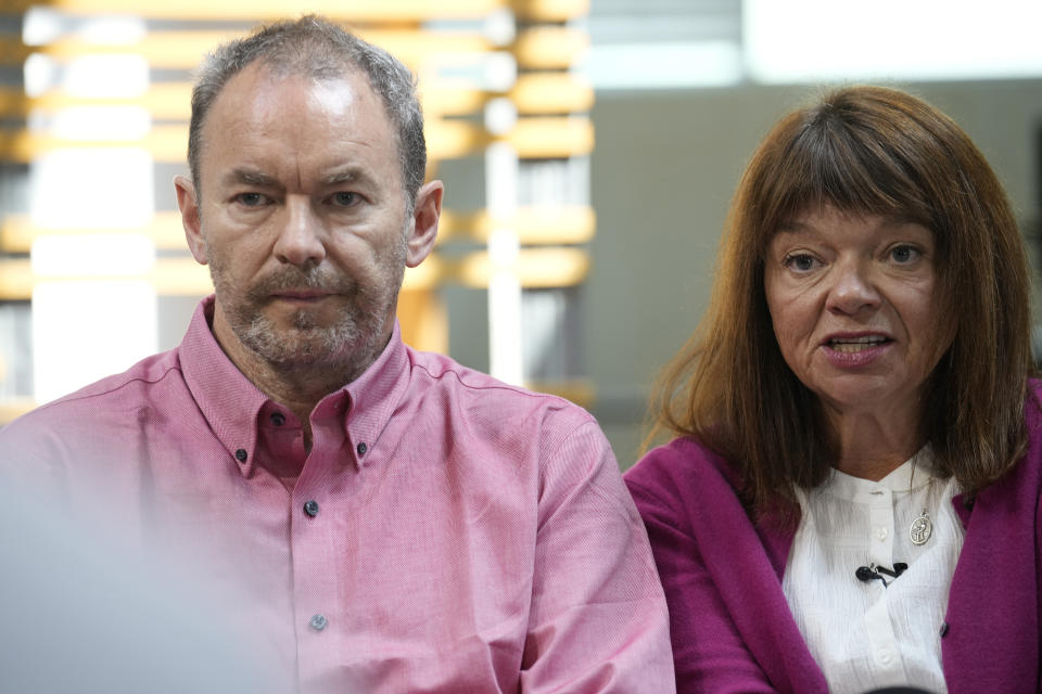 FILE - Simon Glass, left, and his wife, Sally Glass, speak during a news interview in the offices of the couple's lawyers, May 23, 2023, in Denver. Prosecutors on Wednesday, April 24, 2024, urged jurors to convict a former Colorado sheriff's deputy of murder and other charges for shooting and killing Christian Glass, a 22-year-old man in some kind of crisis, after they say the deputy needlessly escalated a standoff with him. (AP Photo/David Zalubowski, File)