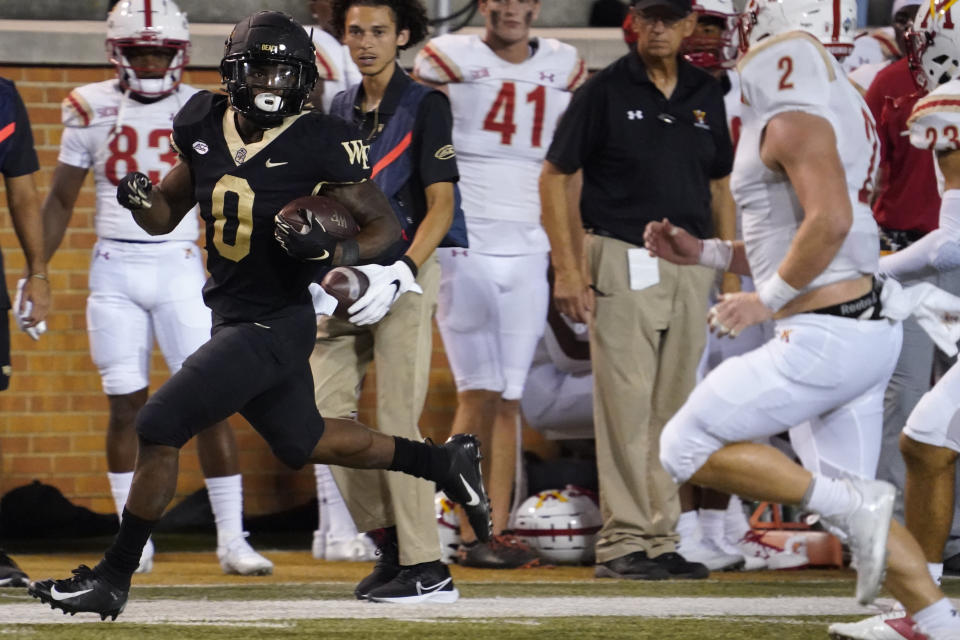 Wake Forest running back Christian Turner (0) breaks away for a long run against VMI during the second half of an NCAA college football game in Winston-Salem, N.C., Thursday, Sept. 1, 2022. (AP Photo/Chuck Burton)