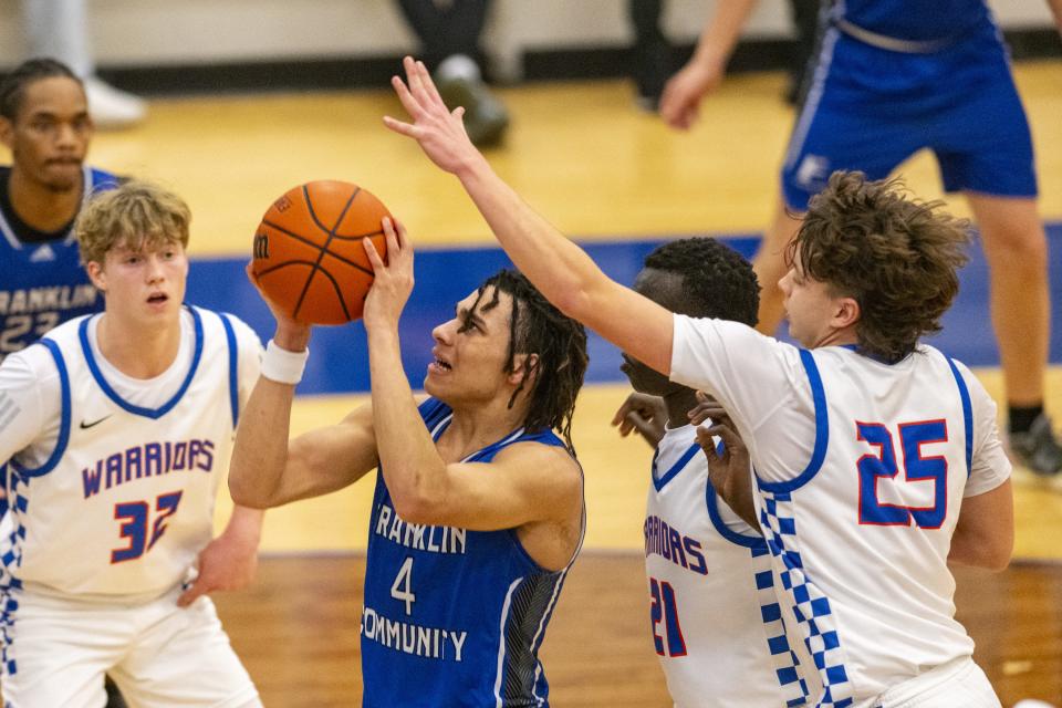 Franklin Community High School senior Micah Davis (4) shoots while Whiteland High School junior Gavin Stubbe (25) attempts to block his shot during the second half of an IHSAA basketball game, Tuesday, Jan. 9, 2024, at Whiteland High School. Whiteland High School won, 67-64.