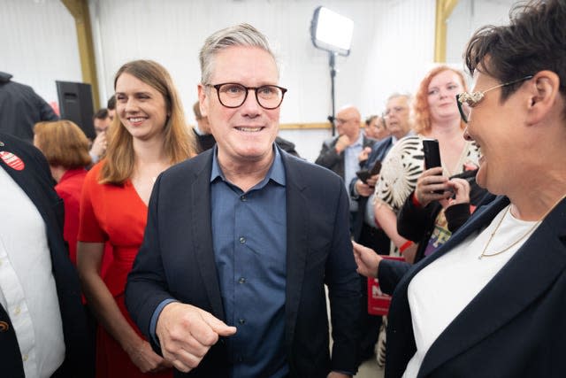 Sir Keir Starmer walks among a crowd at a campaign event