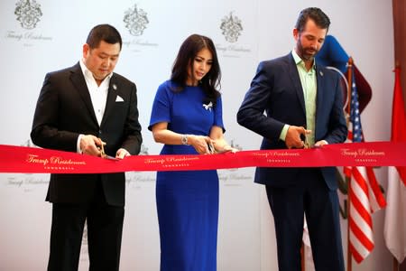 Chairman of MNC Group, Hary Tanoesoedibjo and his wife Liliana Tanaja Tanoesoedibjo, hold scissors with Executive Vice President of The Trump Organization, Donald J. Trump Jr. during pre-launch of the Trump Residences in Jakarta