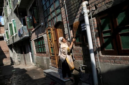 The Wider Image: Barricades and books in restive Kashmir neighbourhood