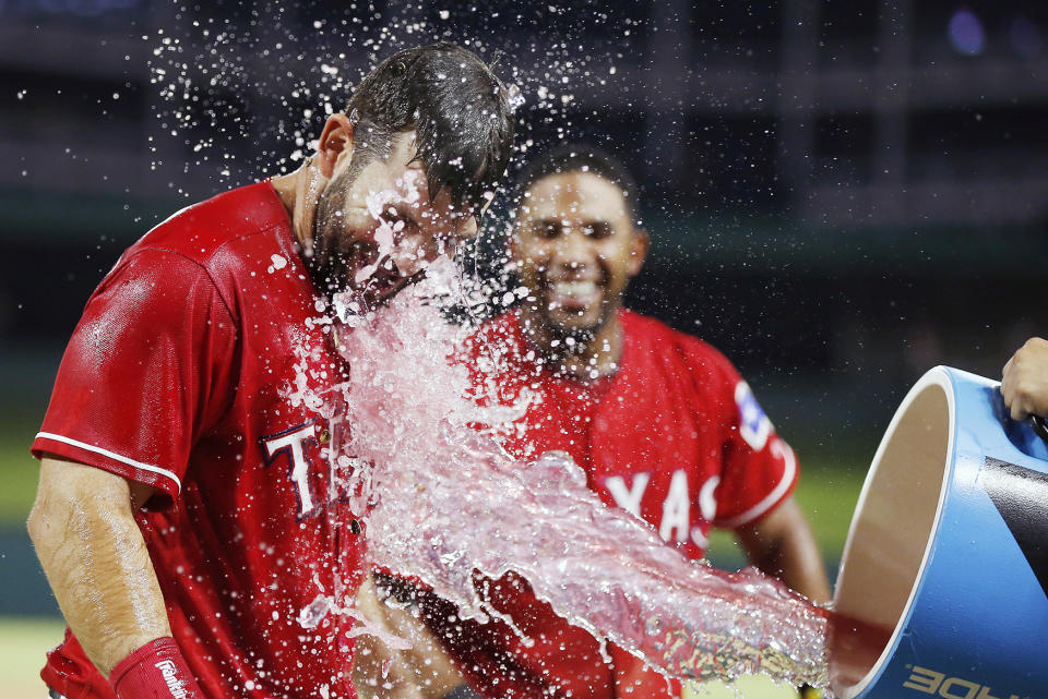 <p>Texas Rangers’ Mitch Moreland, left, is doused by teammate Rougned Odor, right, after hitting a walkoff solo home run in a baseball game against the Kansas City Royals, July 30, 2016, in Arlington, Texas. (Photo: Brandon Wade/AP) </p>