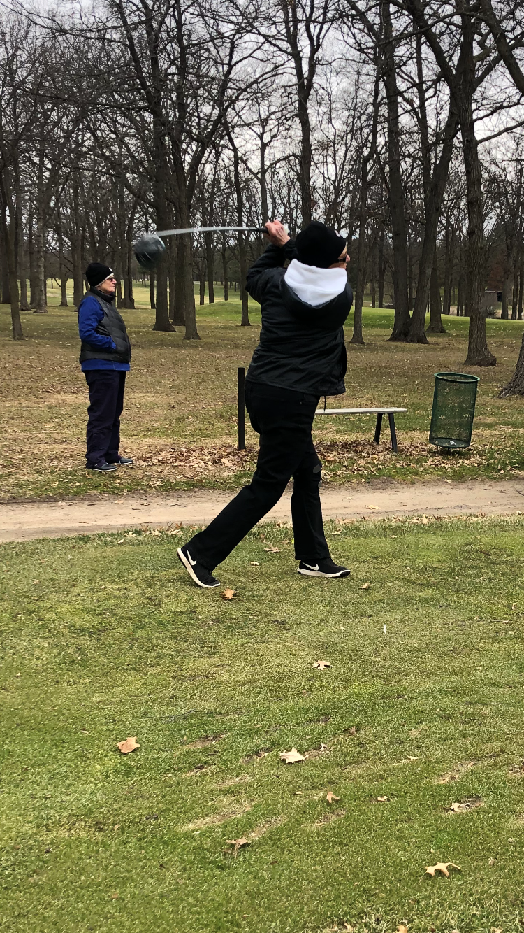 Friend Bernadine Rolle observes Bernie Brown’s tee shot at the 12th hole at Wapicada GC.