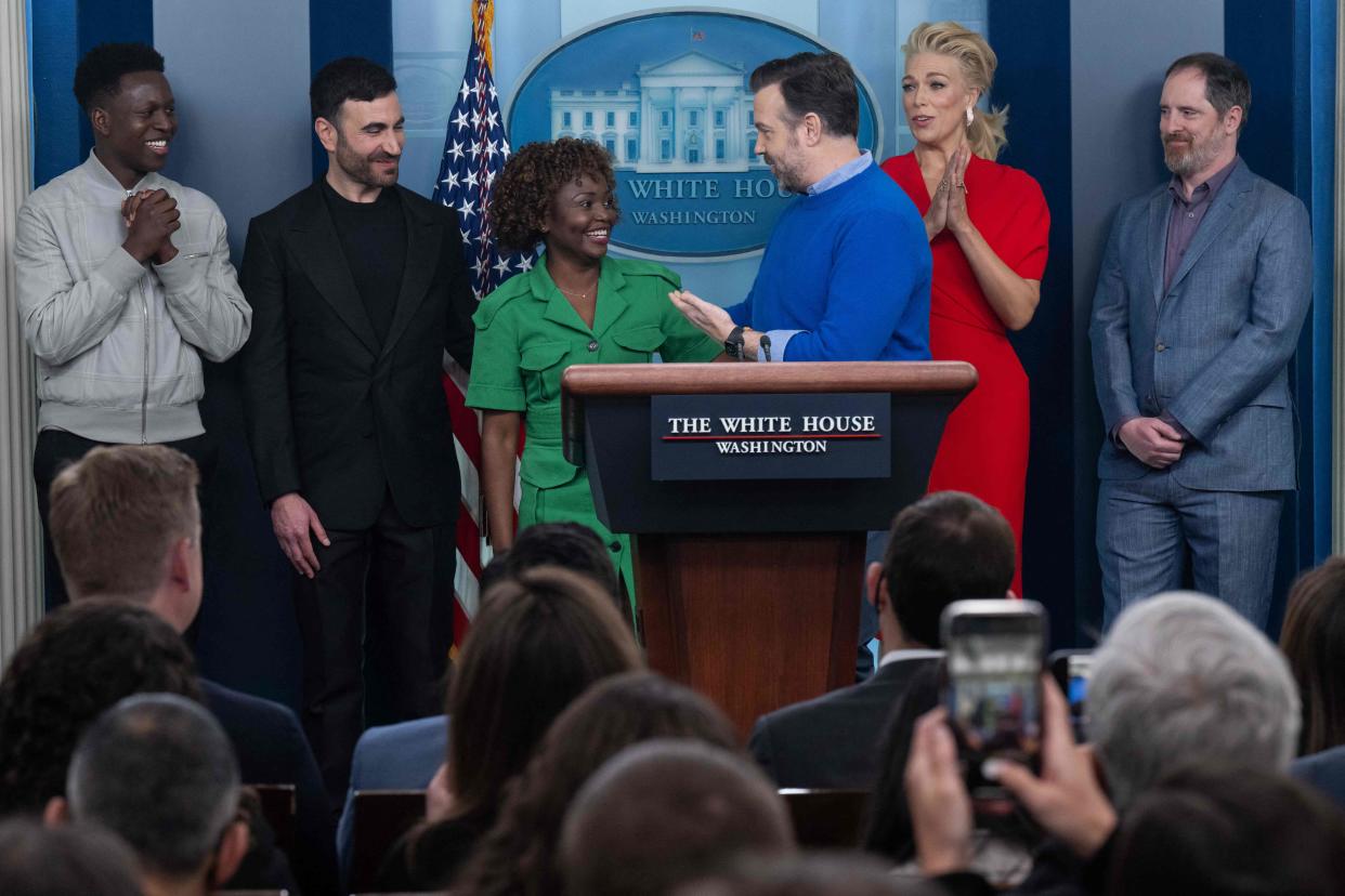 Toheeb Jimoh, from left, Brett Goldstein, Hannah Waddingham and Brendan Hunt look on as Jason Sudeikis, center right, speaks to White House Press Secretary Karine Jean-Pierre, center left, during the daily briefing in the James S Brady Press Briefing Room of the White House on March 20, 2023.