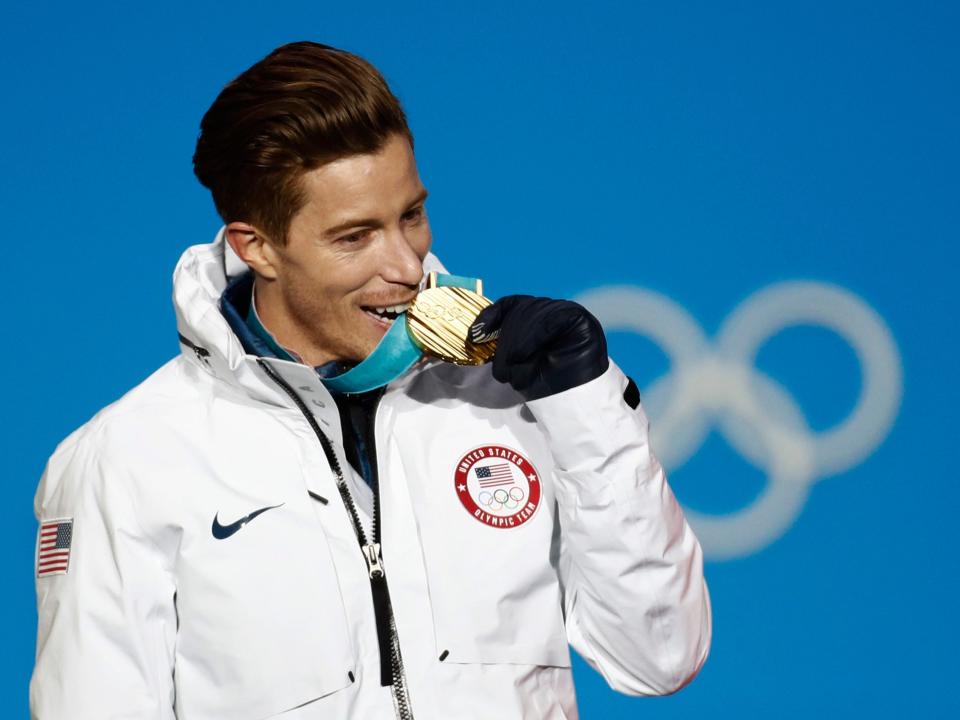 Shaun White poses with his gold medal from the 2018 Olympics.