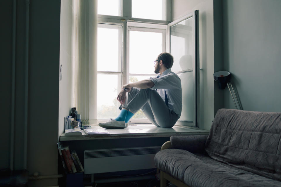 A man sitting and looking out the window