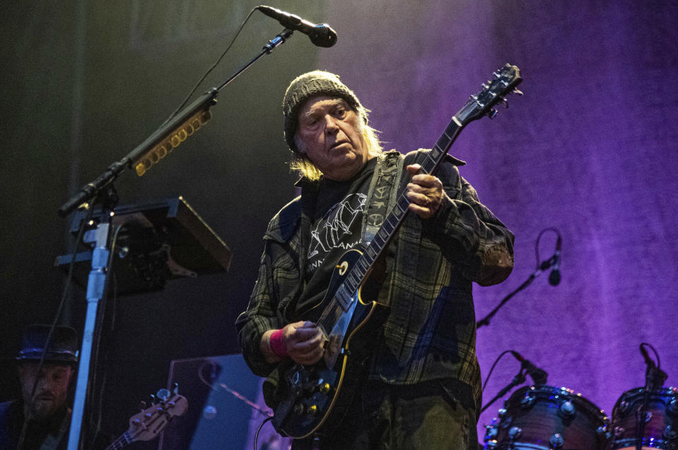 FILE - Neil Young performs at the BottleRock Napa Valley Music Festival at Napa Valley Expo in Napa, Calif., on May 25, 2019. Young had a barn rebuilt in the Rockies and used it to reunite with his old backing band Crazy Horse. The little log structure from the 1850s lends its name to the album that resulted, just called “Barn.” It will be released Friday along with a documentary of the same name directed by Young's wife Daryl Hannah. (Photo by Amy Harris/Invision/AP, File)