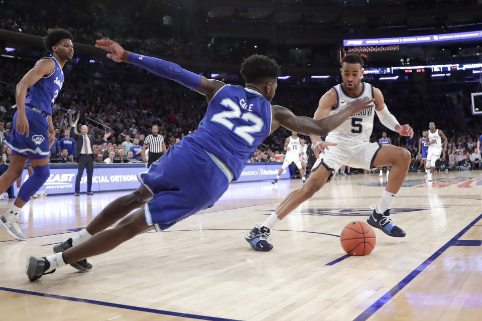 Seton Hall guard Myles Cale (22) and Villanova guard Phil Booth (5) compete for a loose ball during the second half of an NCAA college basketball game in the championship of the Big East Conference tournament, Saturday, March 16, 2019, in New York. Villanova won 74-72. (AP Photo/Julio Cortez)