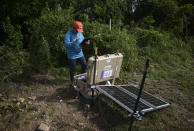 Alena L. Leeds, a scientist from the United States Geological Survey, operates earthquake monitoring and recording equipment amid aftershocks across the island's southern coast where recent quakes have toppled homes and schools in Ponce, Puerto Rico, Tuesday, Jan. 14, 2020. The seismic activity that experts say is unusual but not unexpected has unleashed scientific debate about what’s causing it and drawn international attention to the area, where more than 4,000 people have sought shelter as they wonder when the ground will stop trembling. (AP Photo/Carlos Giusti)