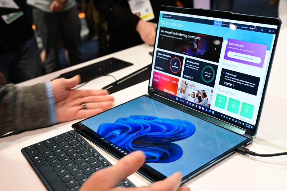 The new Lenovo dual-screen Yoga Book 9i laptop is demonstrated with different screen and keyboard modes at the Microsoft Inc. booth during the Consumer Electronics Show (CES) in Las Vegas, Nevada on January 6, 2023. (Photo by Patrick T. Fallon / AFP) (Photo by PATRICK T. FALLON/AFP via Getty Images)