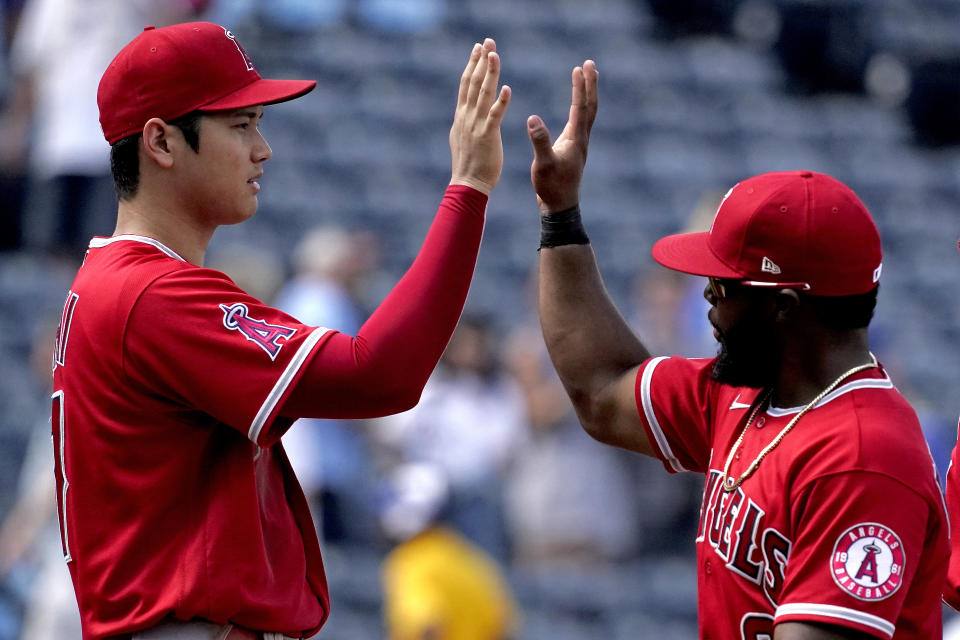 Los Angeles Angels' Shohei Ohtani, left, and Luis Rengifo celebrate after their baseball game against the Kansas City Royals Wednesday, July 27, 2022, in Kansas City, Mo. The Angels won 4-0. (AP Photo/Charlie Riedel)