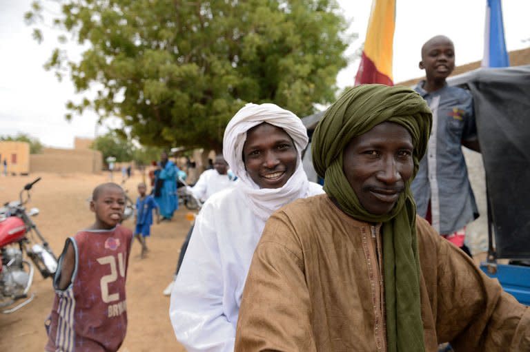 Touareg people celebrate in Diafouke as Malian and French soldiers entered the historic city of Timbuktu, occupied for 10 months by Islamists who imposed a harsh form of sharia, on January 28, 2013